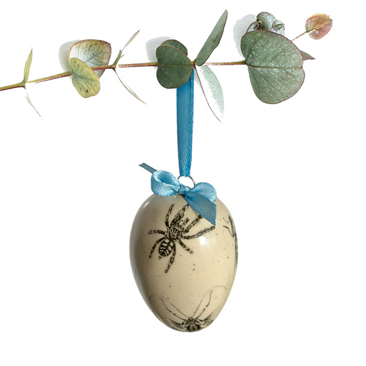 Jajko wielkanocne z błękitną wstążeczką. Pajączek i żuczki.