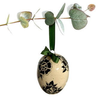 Jajko wielkanocne z zieloną wstążeczką. Kwiaty z tatuaży srebrzyste i czarne